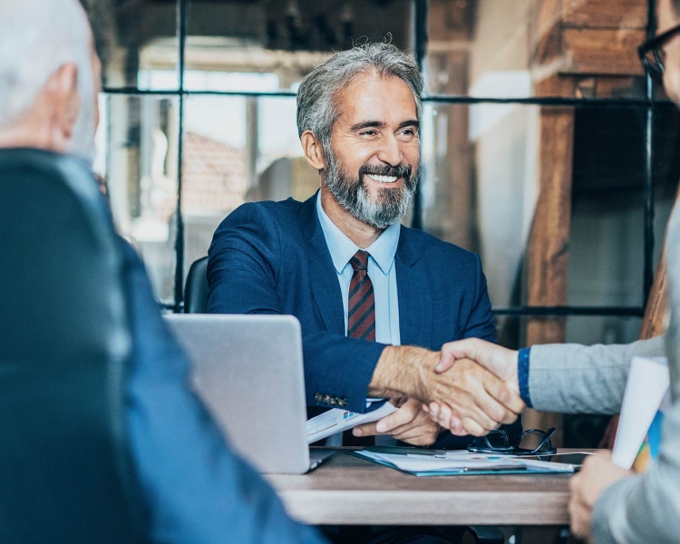 Man shakes hand of another person