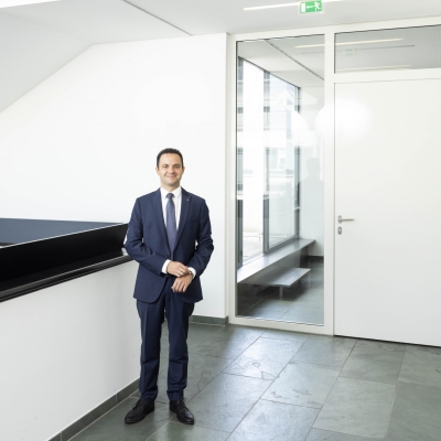 BTV Mitarbeiter Mario Scherl im eleganten Anzug im Stiegenhaus.