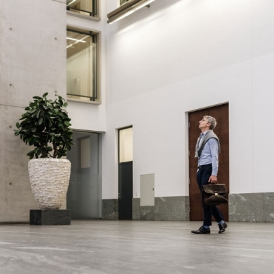 Man with is walking in a bank building.