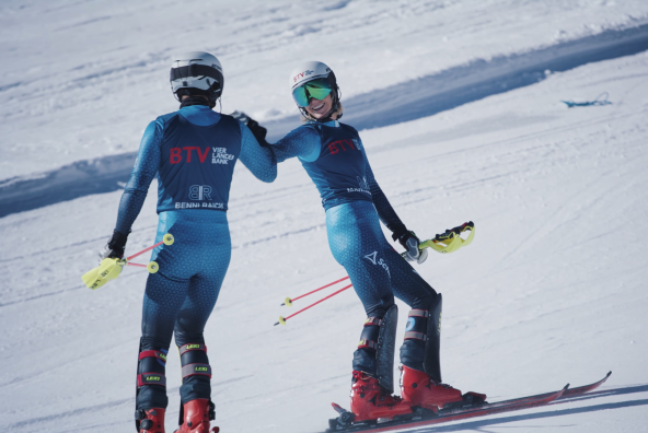 Marlies und Benni Raich stehen als BTV Markenbotschafter auf einer Skipiste und geben sich lächelnd die Hand.