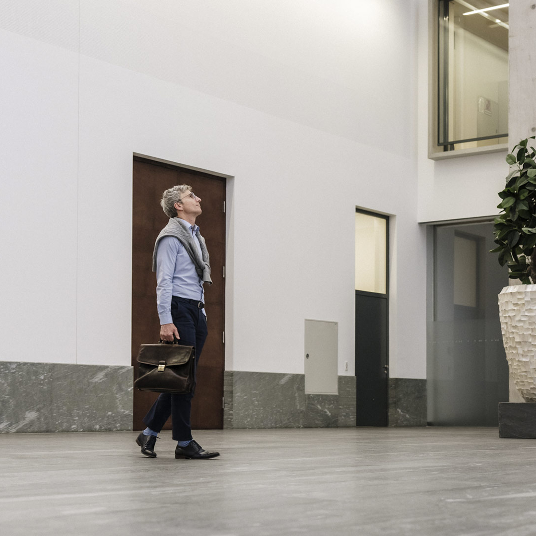 Man with shirt is walking in a bank.